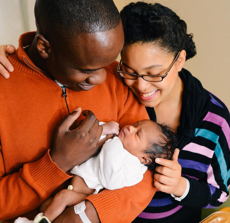 Noah just about 22 hours old (December 1 at 3:35 pm) with parents during a photo shoot in Room 428